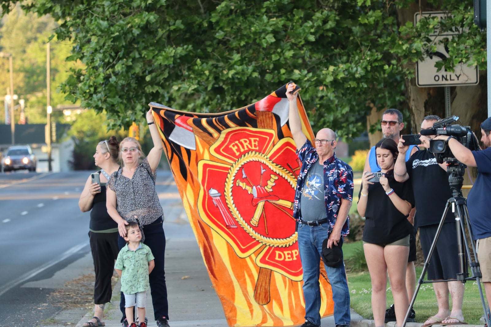 A procession from Kootenai Health headed to Spokane after a few firefighters were killed Sunday, June 29, 2025, when they were ambushed by sniper fire while responding to a blaze in a northern Idaho mountain community, in Coeur d’Alene, Idaho. (Bill Buley/Coeur D'Alene Press via AP)