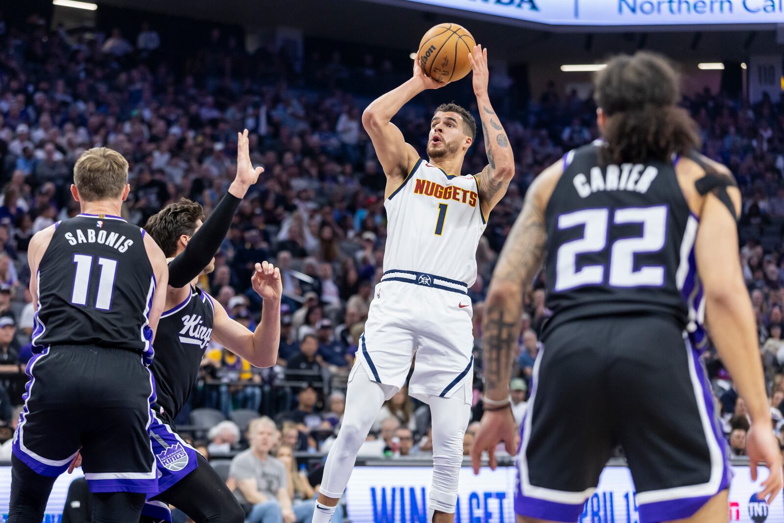 Denver Nuggets forward Michael Porter Jr. (1) goes up for a shot as Sacramento Kings forward Doug McDermott, left center, defends during the first half of an NBA basketball game Wednesday, April 9, 2025, in Sacramento, Calif. (AP Photo/Sara Nevis)