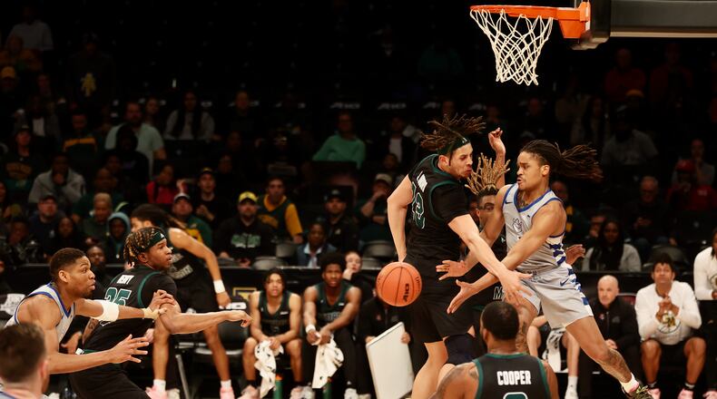 Yuri Collins, of Saint Louis, makes a pass against George Mason in the quarterfinals of the Atlantic 10 Conference tournament on Thursday, March 9, 2023, at the Barclays Center in Brooklyn, N.Y. David Jablonski/Staff
