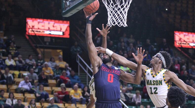 George Mason's A.J. Wilson, right, fouls Dayton's Josh Cunningham on Wednesday, Feb. 14, 2018, at EagleBank Arena in Fairfax, Va.