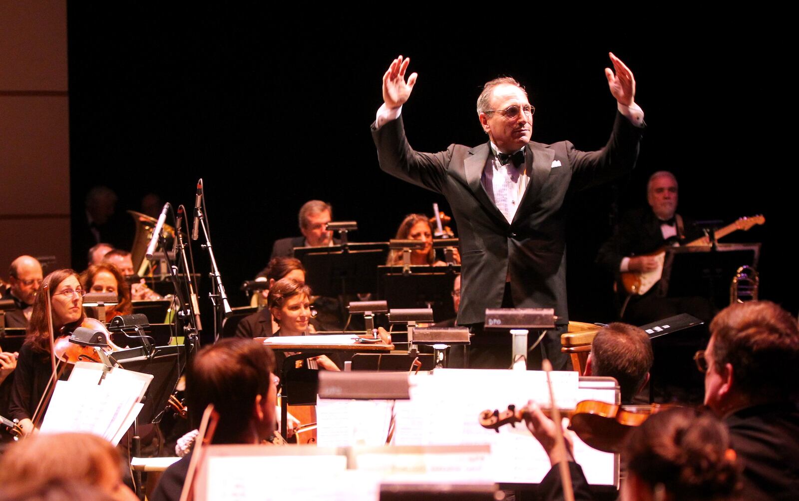 Dayton Philharmonic Orchestra Music Director, Neal Gittleman, conducts "Hang On Sloopy" during the inaugural Dayton Performing Arts Alliance Gala held at the Benjamin and Marian Schuster Performing Arts Center in Dayton Saturday, Oct. 5, 2013. NICK DAGGY / STAFF
