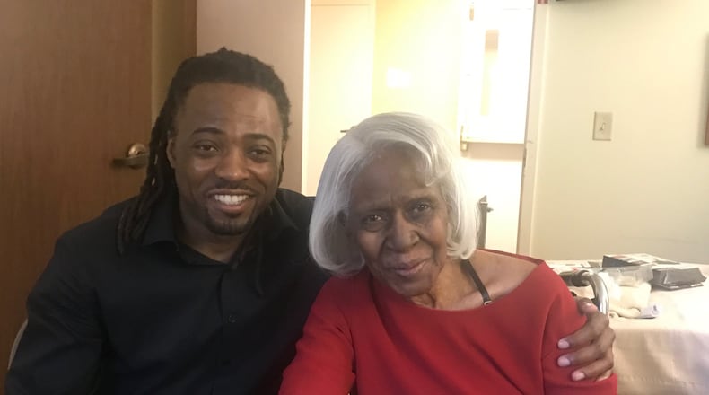 Mike Evans with his grandmother Emmaline Ross, the woman who raised him, at the Siena Woods Senior Living Center on N. Main Street in Dayton. Tom Archdeacon/STAFF