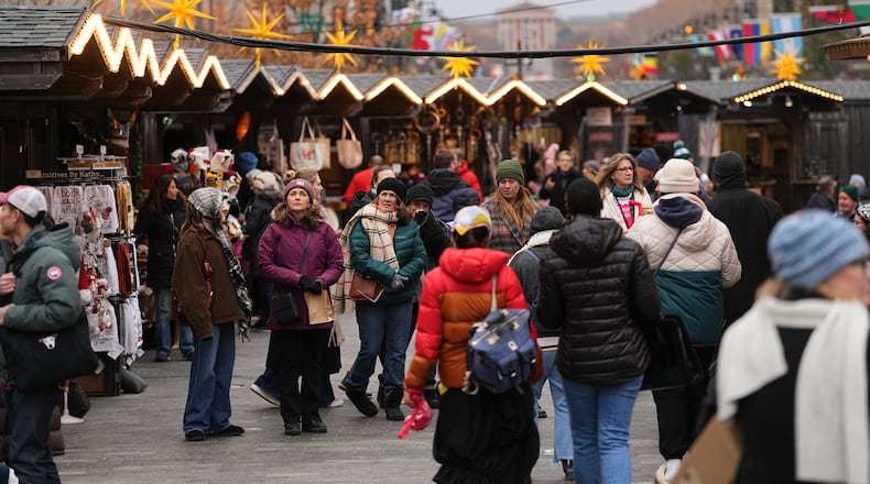 FILE - People shop at the Christmas Village in Philadelphia, in Philadelphia, Wednesday, Dec. 10, 2025. (AP Photo/Matt Rourke, File)