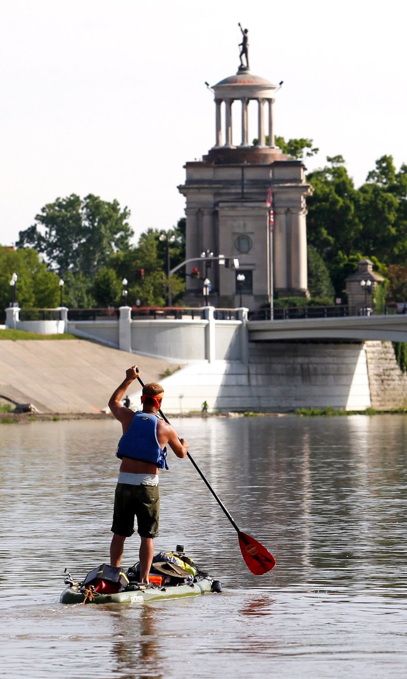 Tom Helbig, of Tomfoolery Outdoors, stand-up paddles into Hamilton Thursday evening June 5, 2014, on the eighth day of his 126 mile journey of the Great Miami River from its start at Indian Lake in northern Ohio to it’s end at the Ohio River west of Cincinnati. NICK DAGGY / STAFF