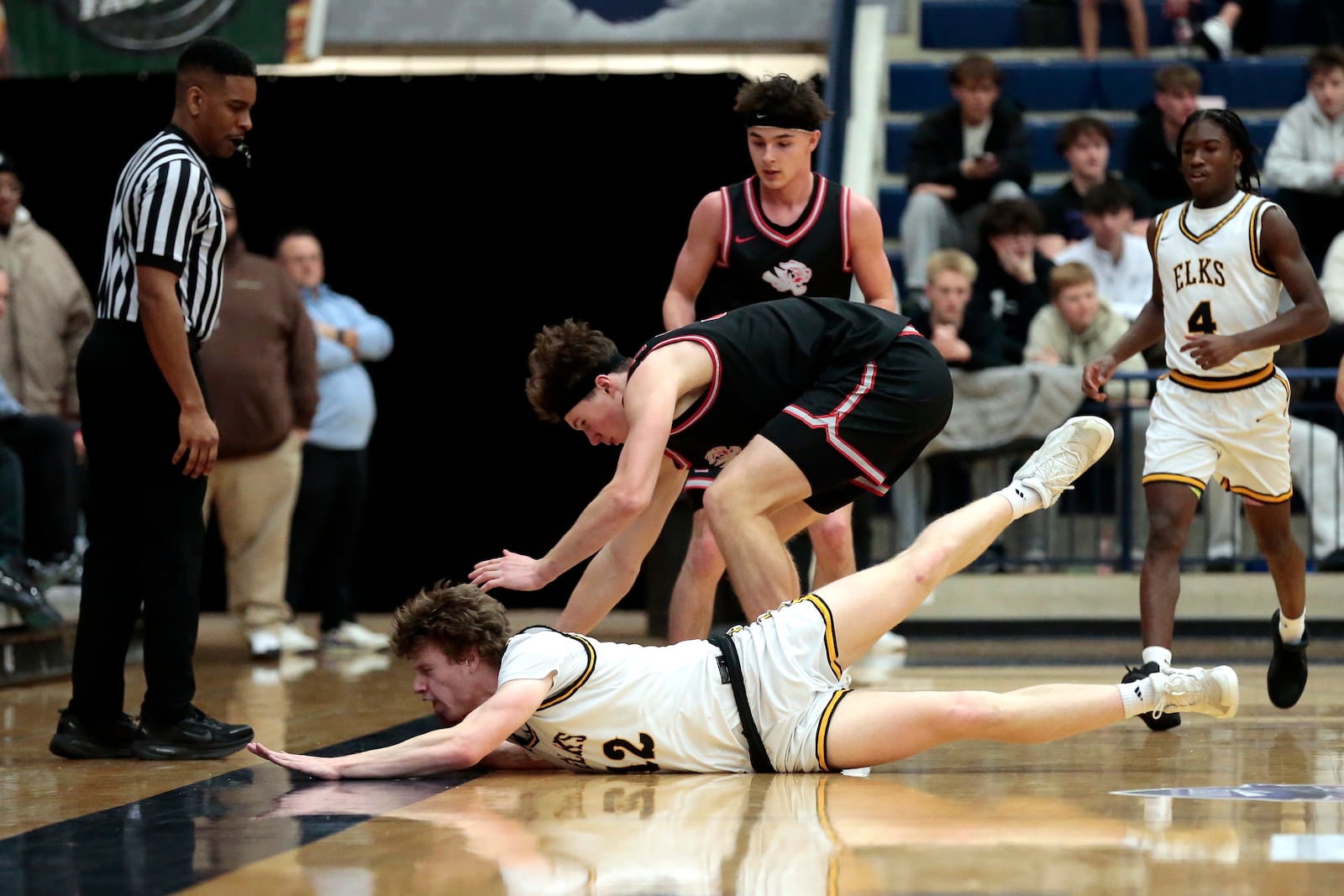 Centerville junior Calvin Walsworth dives for a loose ball going off the floor. Fishers (Ind.) defeated Centerville 55-43 on Saturday, Jan. 17, 2026, at The Beacon Orthopaedics Flyin' to the Hoop showcase at Trent Arena in Kettering. STEVEN WRIGHT / STAFF