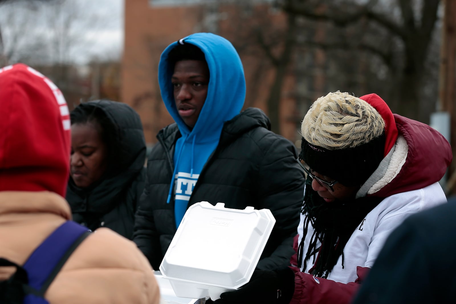 Jamier Brown, a junior football player at Wayne High School, was one of the first to use new Name, Image and Likeness rules for Ohio high school athletes in organizing a Thanksgiving food giveaway on Wed., Nov. 26, 2025, at Riverview Park. STEVEN WRIGHT / STAFF