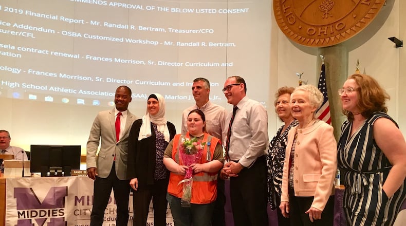The Middletown Board of Education honored school bus driver Kim Plott - center with flowers - as a hero during its meeting last week. Plott saved a student’s life last month when she used the Heimlich maneuver to dislodge a piece of candy from the choking child’s throat.
