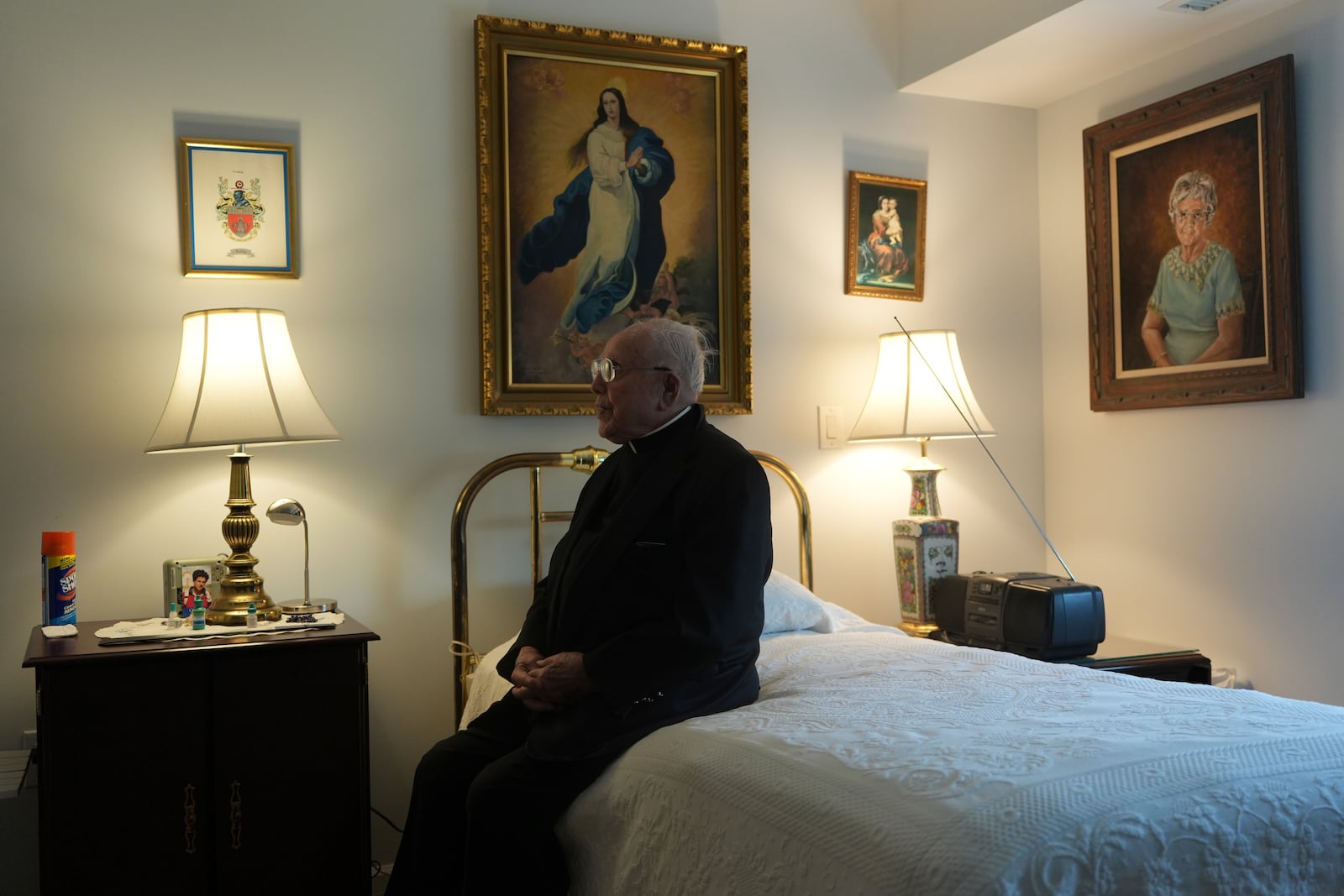 The Rev. James Kelly sits in his apartment in the Normandy Farms Estates retirement community in Blue Bell, Pa., on Wednesday, June 18, 2025. (AP Photo/Luis Andres Henao)