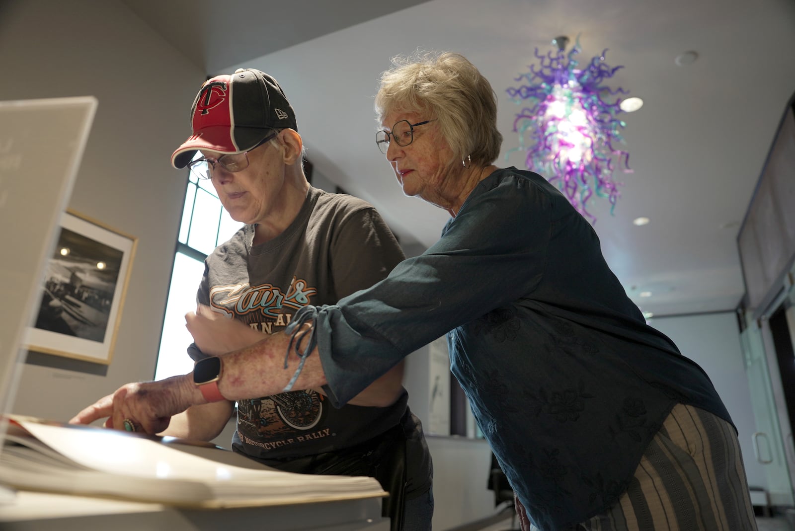 Jacque Farnham, left, looks at a book with her mother, Janith, in the Visual Arts Center at the Washington Pavilion in Sioux Falls, S.D., on May 20, 2025. (AP Photo/Shelby Lum)