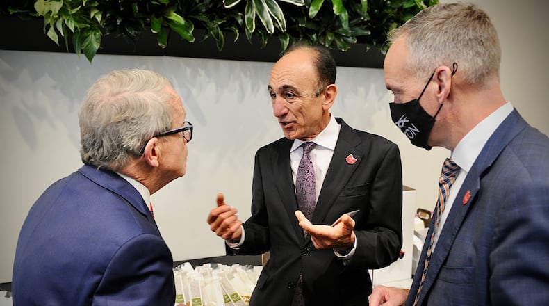 Ohio Governor Mike DeWine, left, talks with Fatih Ozmen, CEO of Sierra Nevada Corp, middle and Jeff Hoagland, CEO of Dayton Development Coalition Wednesday February 2, 2022 just before the Groundbreaking ceremony of the Sierra Nevada’s new aviation modification facility at Dayton international airport. MARSHALL GORBY \STAFF