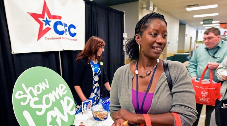 Tracy Weaver, a program manager at Acquisition, Environmental and Facilities Division, Air Force Life Cycle Management Center, visits the Combined Federal Campaign’s own awareness table, staffed by one of last year’s loaned executives, Heather Atkinson, at the Oct. 2 kickoff. (U.S. Air Force photo/Ty Greenlees)