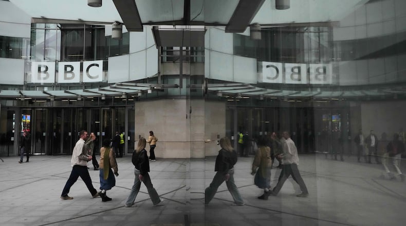 FILE - Pedestrians are reflected as they walk outside BBC Broadcasting House in London, Tuesday, Nov. 11, 2025. (AP Photo/Kirsty Wigglesworth, file)