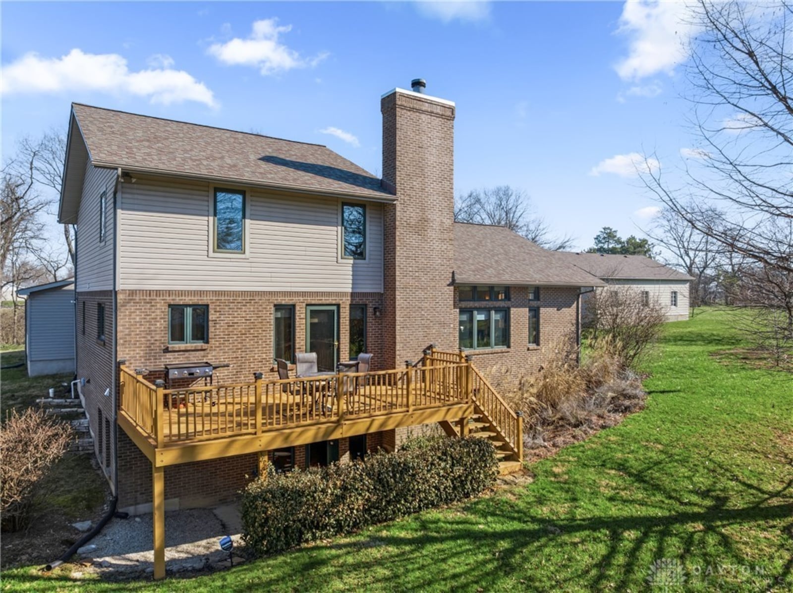 The back of the two story addition has a wood deck with wood railings and steps leading down to the yard and walk out basement. CONTRIBUTED