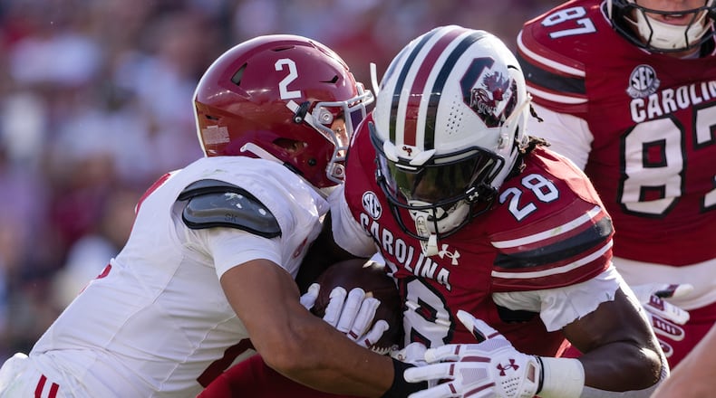 Alabama defensive back Zabien Brown (2) tackles South Carolina running back Matt Fuller (28) during the first half of an NCAA college football game, Saturday, Oct. 25, 2025, in Columbia, S.C. (AP Photo/Scott Kinser)