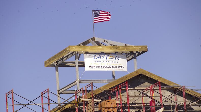The final steel beam of the new Wogaman school on Germantown Street was hoisted into place in January 2006. Nearly 14 years later, Dayton Public Schools officials are weighing how much to spend for maintenance on their relatively new schools. FILE PHOTO