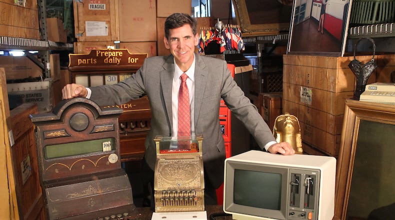 Dayton History President & CEO Brady Kress with items from the NCR archives. CONTRIBUTED PHOTO