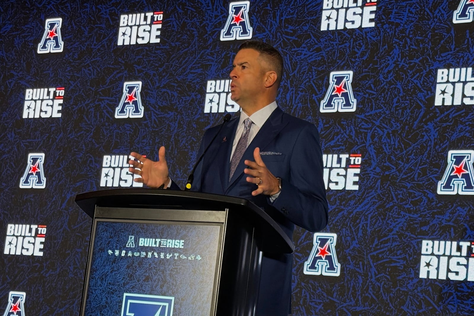 American Conference commissioner Tim Pernetti speaks at Media Days on Friday, July 25, 2025 in Charlotte, N.C. (AP Photo/Steve Reed)