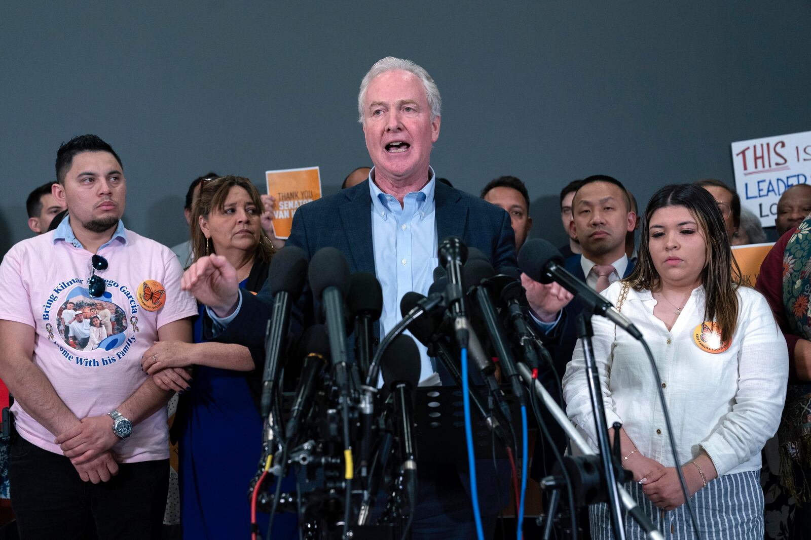 Sen. Chris Van Hollen, D-Md., center, accompanied by Cesar Abrego Garcia, from left, Cecilia Garcia and Jennifer Vasquez Sura, speaks during a news conference upon his arrival from El Salvador at Washington Dulles International Airport, in Chantilly, Va., Friday, April 18, 2025, in Washington. (AP Photo/Jose Luis Magana)