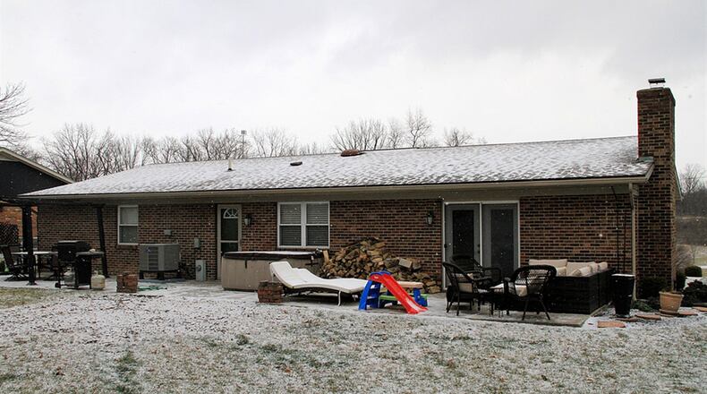 A door off the laundry room opens to the extended concrete patio, which was poured in 2014 along with the front driveway.