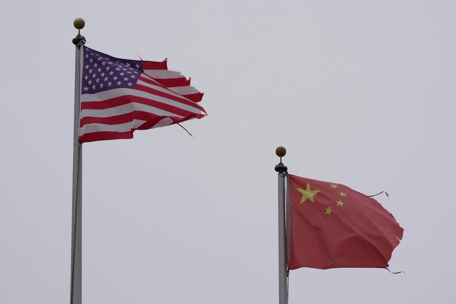 A flag of the United States flies next to a flag of China in Chinatown in San Francisco, Friday, April 18, 2025. (AP Photo/Jeff Chiu)