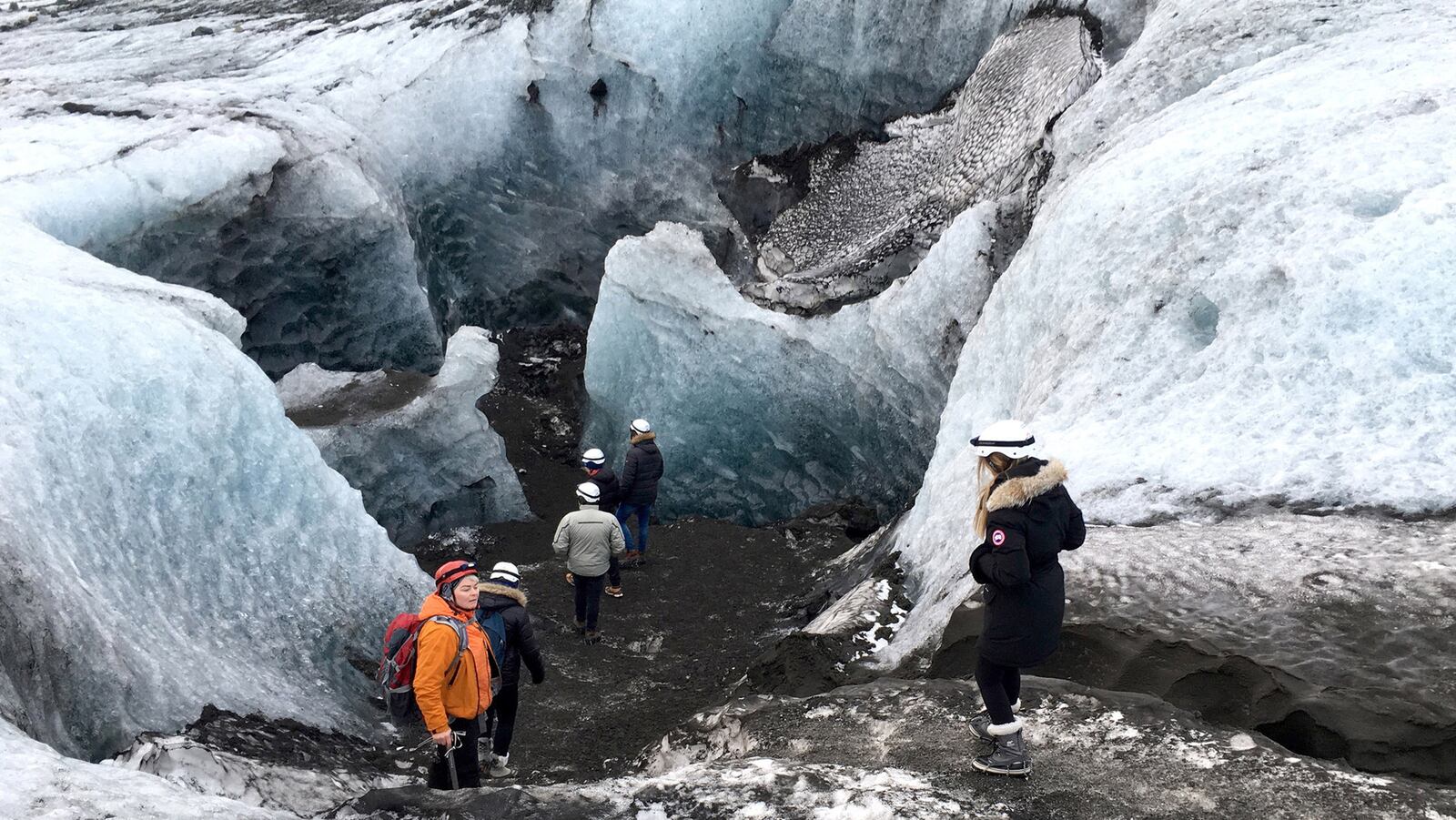 Tourists descend to get a close look at parts of ice caves in Skaftafell, a wilderness area in Vatnajokull National Park. (Jessica Kwong/Orange County Register/TNS)
