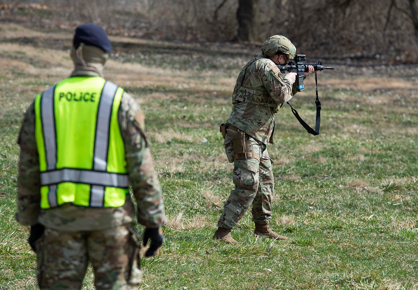 A member of the 88th Security Forces Squadron fires a Simunition round at a fixed target with an M4 carbine rifle as Staff Sgt. Sherman Gramby, a unit training instructor, observes during sustainment training March 17 at Wright-Patterson Air Force Base. U.S. AIR FORCE PHOTO/WESLEY FARNSWORTH