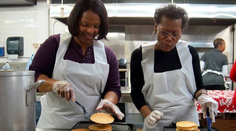Volunteers at last year’s Day of Caring kept the pancakes coming. CONTRIBUTED