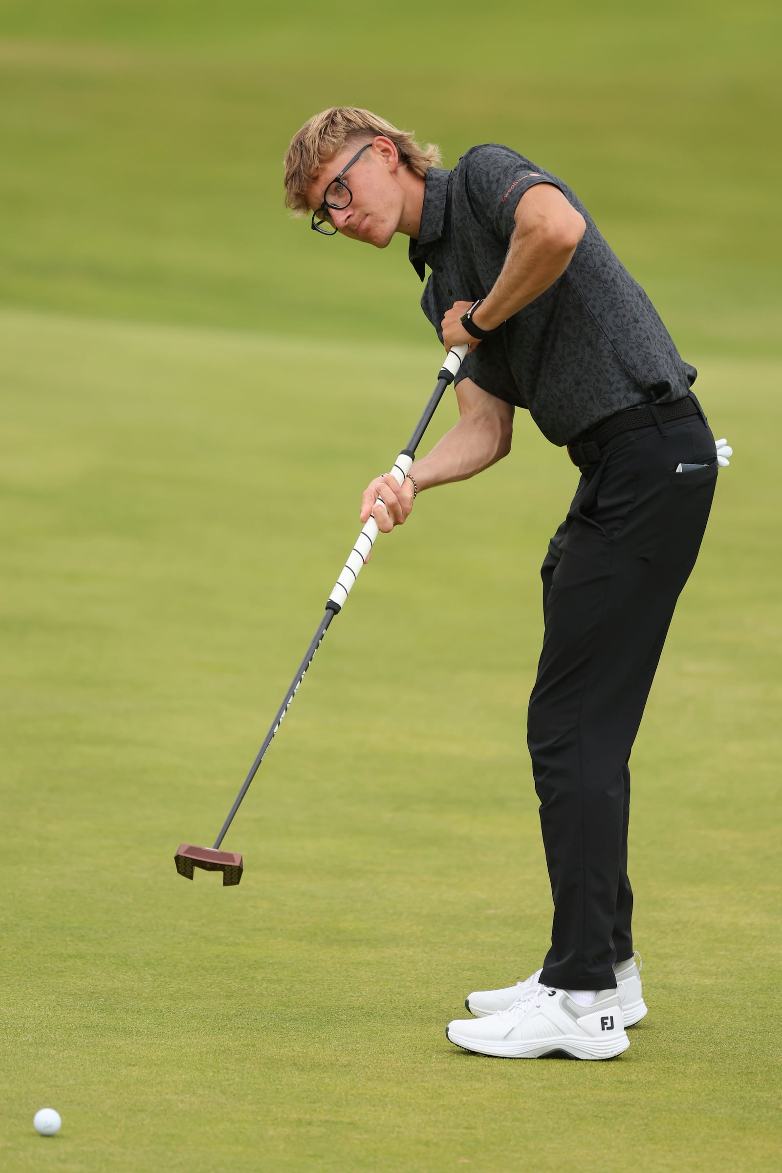 Richard Teder of Estonia putts on the 1st green during a practice round for the British Open golf championship at the Royal Portrush Golf Club, Northern Ireland, Tuesday, July 15, 2025. (AP Photo/Peter Morrison)