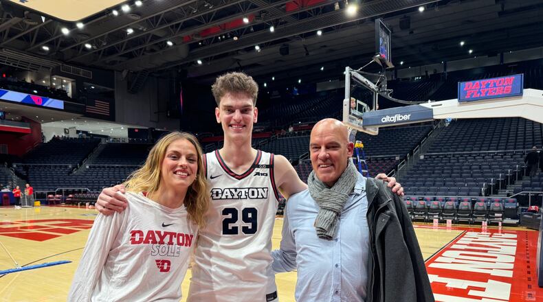 After registering the first double-double of his college career – 13 points and 10 rebounds against Capital University  at UD Arena Saturday night – Amaël L'Etang, the Dayton Flyers 7-foot- forward, met on the edge of the court with his father, Frédéric, who is visiting from France and his sister Amandine, once a junior college basketball player in Texas and now an au pair in New York City. Chris Grant/CONTRIBUTED
