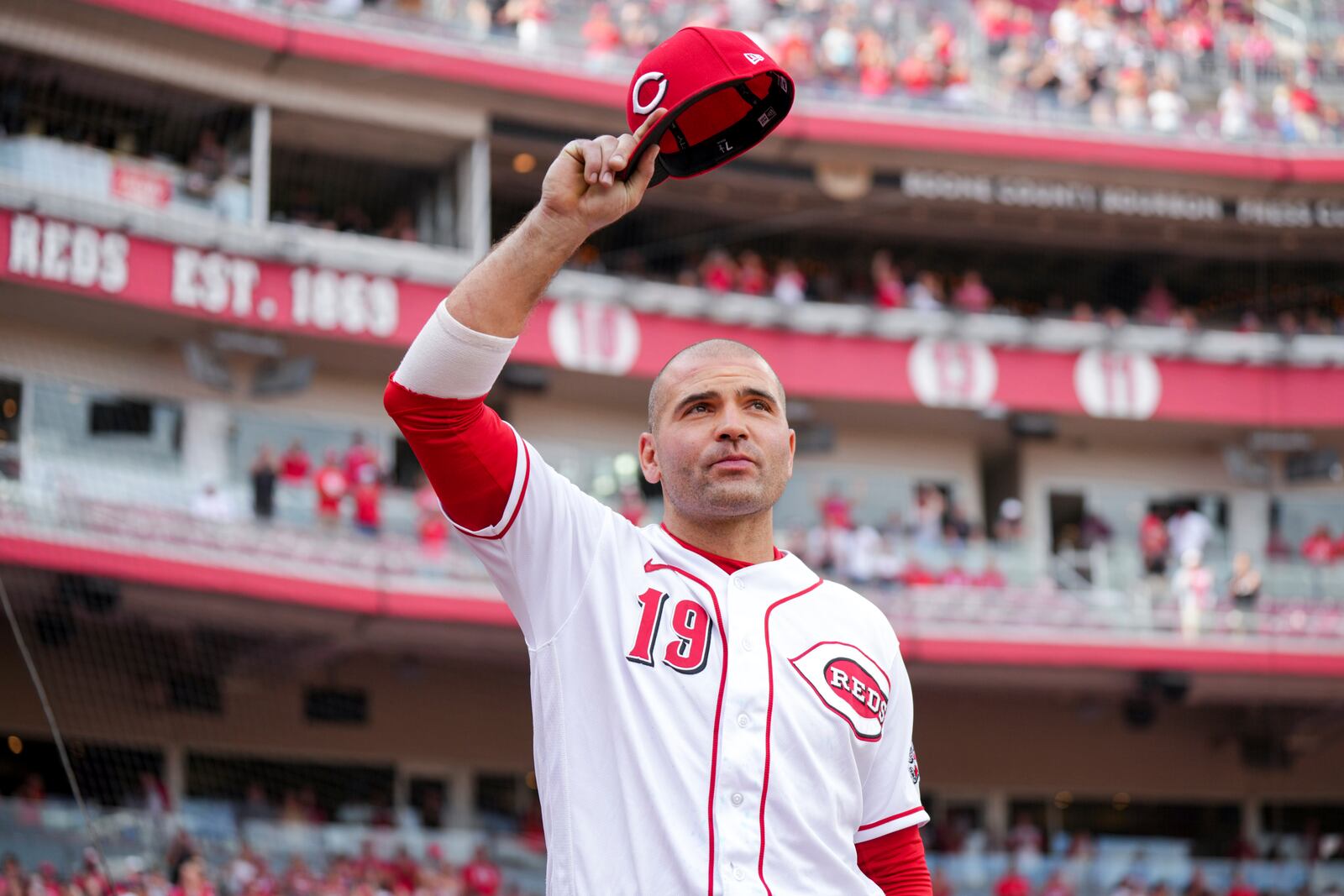 Cincinnati Reds' Joey Votto acknowledges the crowd as he walks off the field after a baseball game against the Pittsburgh Pirates in Cincinnati, Sunday, Sept. 24, 2023. (AP Photo/Aaron Doster)