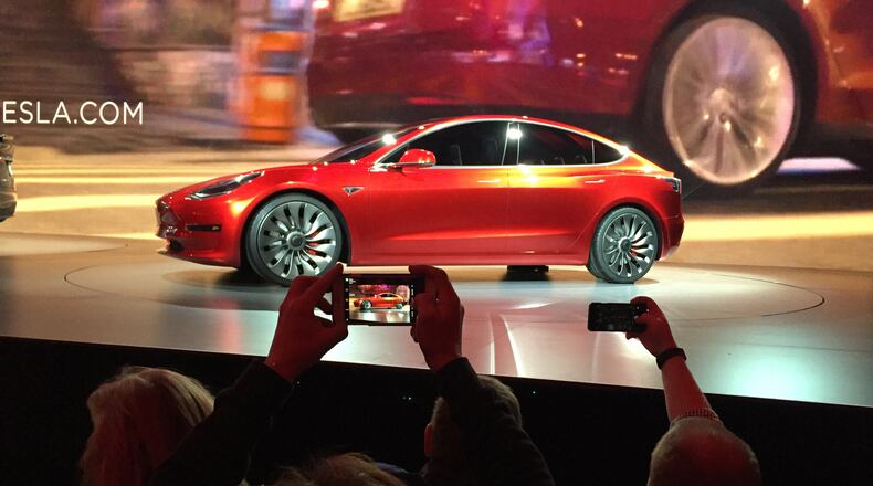 In March 2016, Tesla Motors unveiled the new lower-priced Model 3 sedan at a design studio in Hawthorne, Calif. More than 276,000 people pre-ordered the Model 3 in less than a week. (AP Photo/Justin Pritchard)