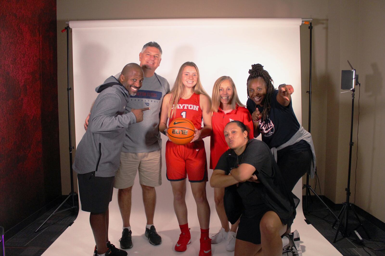 Lauren Pallotta and her parents pose for a photo with the UD coaching staff on her visit to Dayton. Contributed photo