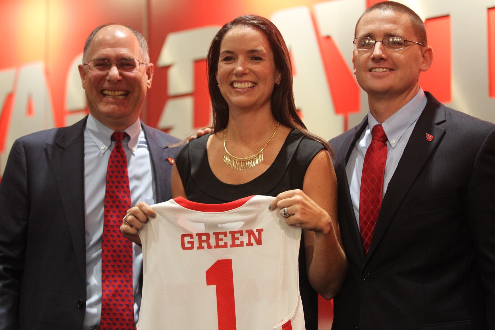 Dayton President Eric F. Spina, women’s basketball coach Shauna Green and Athletic Director Neil Sullivan pose for a photoat a press conference where Green was introduced as Dayton women’s basketball coach on Wednesday, Sept. 14, 2016, at UD Arena. David Jablonski/Staff