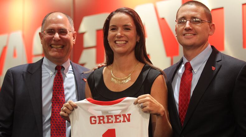 Dayton President Eric F. Spina, women’s basketball coach Shauna Green and Athletic Director Neil Sullivan pose for a photoat a press conference where Green was introduced as Dayton women’s basketball coach on Wednesday, Sept. 14, 2016, at UD Arena. David Jablonski/Staff
