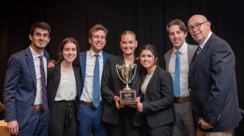 The UD sales team poses with their first-place trophy. Photo from left: Junior John Sommers, Senior Clare Gaffney, Senior Will Blubaugh, Junior Alexa Plummer, Senior Gabby Rullo, Junior Hans Rottmann, and Faculty Sales Coach Tony Krystofik. Courtesy of University of Dayton.