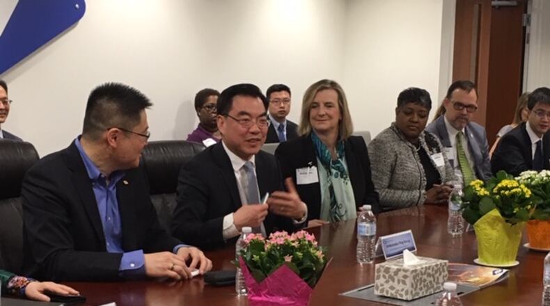 Huang Ping, consul general in New York for China, oversees China’s largest consulate in the world. In a visit Wednesday to Fuyao Glass America’s Moraine plant, Ping sat between Jeff Liu, Fuyao Glass America plant manager (left), and Cheryl Schrader, president of Wright State University (right). THOMAS GNAU/STAFF