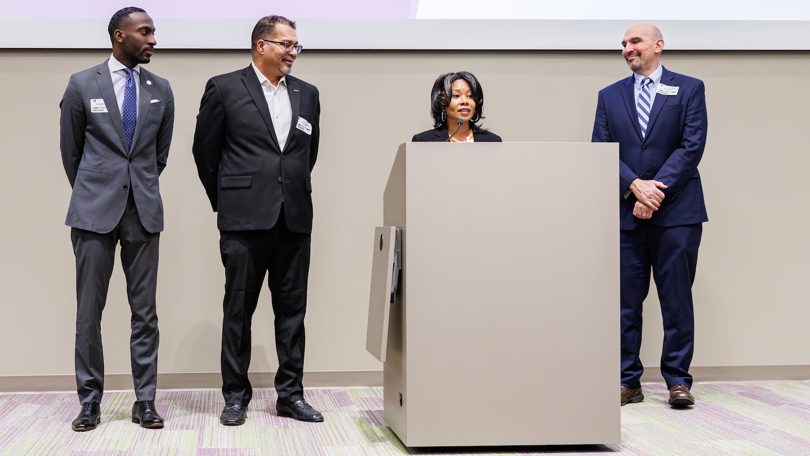 Dayton Mayor Shenise Turner-Sloss (center right) speaks at an event at CareSource on Thursday, Dec. 8 in downtown Dayton as City Commissioners Darius Beckham (far left), Chris Shaw (center left) and Matt Joseph listen. Turner-Sloss started her first term as Dayton’s mayor this month. In a full room at CareSource’s Pamela Morris Center in Dayton, she said partnerships are key. BRYANT BILLING/STAFF