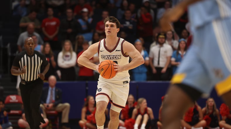 Dayton's Brady Uhl makes a pass against Cedarville in an exhibition game on Saturday, Oct. 28, 2023, at UD Arena. David Jablonski/Staff