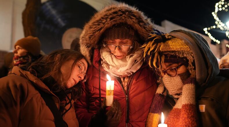 People attend a vigil where Alex Pretti was shot and killed by federal immigration enforcement in Minneapolis, on Wednesday, Jan. 28, 2026. (AP Photo/Adam Gray)