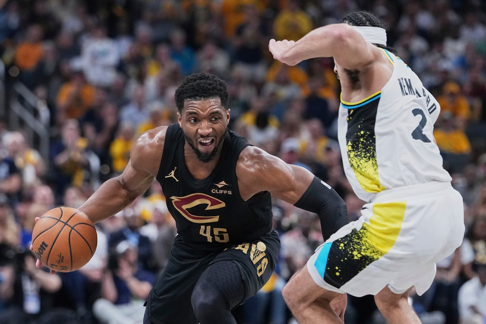 Cleveland Cavaliers guard Donovan Mitchell (45) drives to the basket against Indiana Pacers guard Andrew Nembhard (2) in the first half of Game 4 in the Eastern Conference semifinals of the NBA basketball playoffs in Indianapolis, Sunday, May 11, 2025. (AP Photo/Michael Conroy)