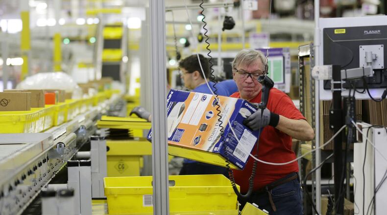 Mark Oldenburg processes outgoing orders at Amazon.com’s fulfillment center in DuPont, Wash. Shoppers spent more than $3 billion online this “Cyber Monday,” making it the biggest online shopping day ever. (AP Photo/Ted S. Warren, File)
