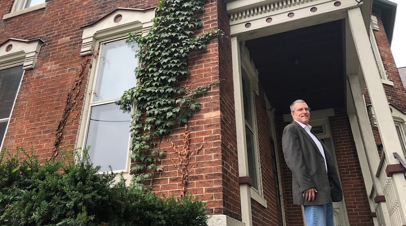 Pat Tuffey stands on the porch of the old Daybreak facility on the 800 block of Wayne Avenue. Tuffey and four other partners want to reuse the facility as a drug and alcohol treatment center. CORNELIUS FROLIK / STAFF