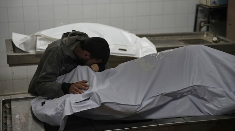 Magdi Abu Al-Khair bids farewell to his mother, Amal Abu Al-Khair, after she and her grandchild, Saud, were killed when their tent caught fire overnight at the Yarmouk displacement camp, at Al-Shifa Hospital in Gaza City, Friday, Jan. 2, 2026. (AP Photo/Jehad Alshrafi)