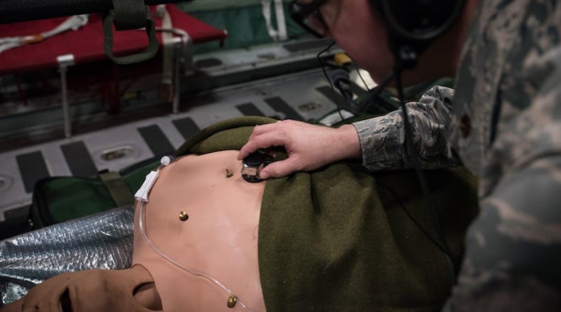 While testing the new stethoscope, Maj. Daniel Bevington, a nurse researcher in the 711th Human Performance Wing of Air Force Research Laboratory, places the device on a mannequin’s chest to listen to internal sounds. (U.S. Air Force photos/Richard Eldridge)