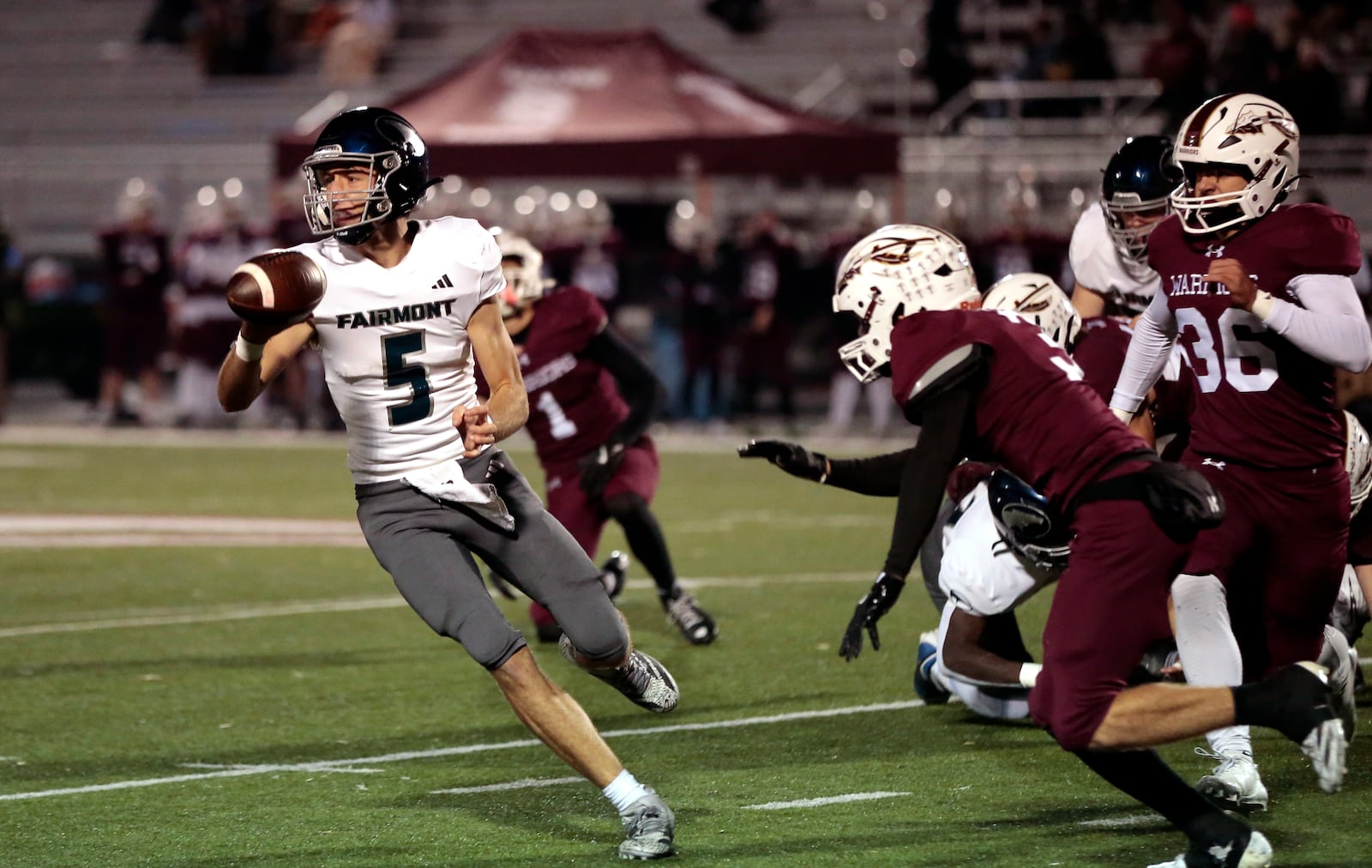 Fairmont senior J. J. Hill pitches a ball as he avoids the incoming rush. Lebanon won 22-21 in an OHSAA Division I first round playoff game, Fri. Oct. 31, 2025, in Lebanon. STEVEN WRIGHT / STAFF