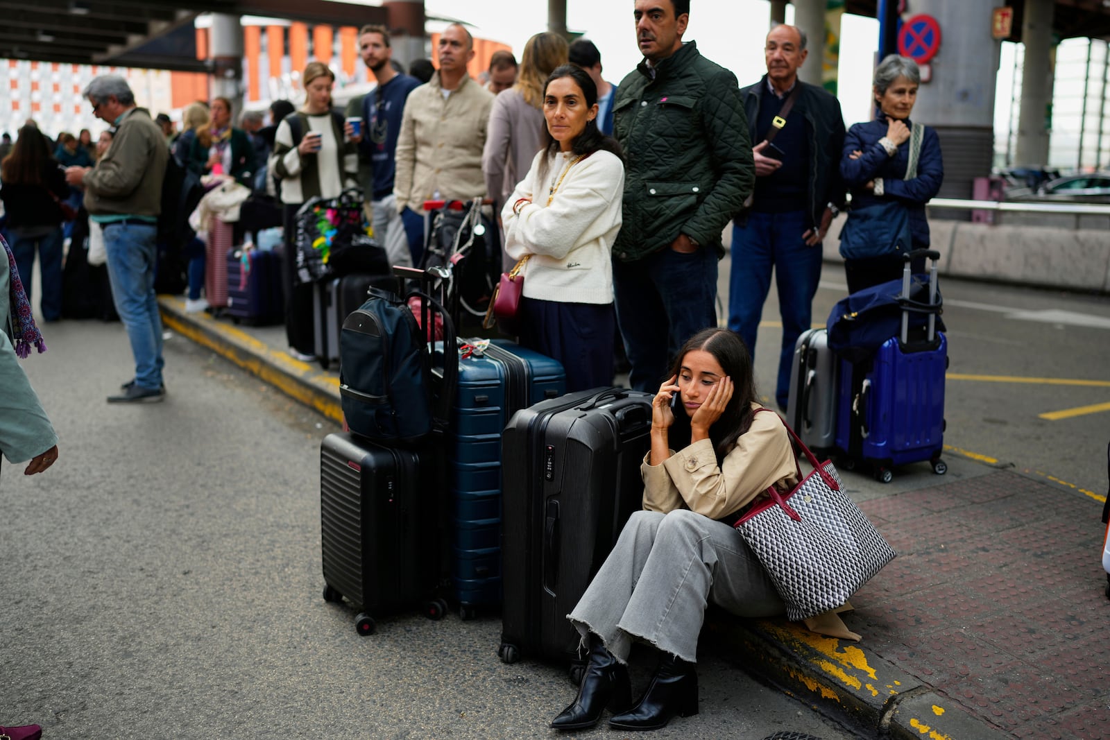 Travelers wait for news about their delayed trains at the Madrid train station, Spain, Monday, May 5, 2025. (AP Photo/Manu Fernandez)
