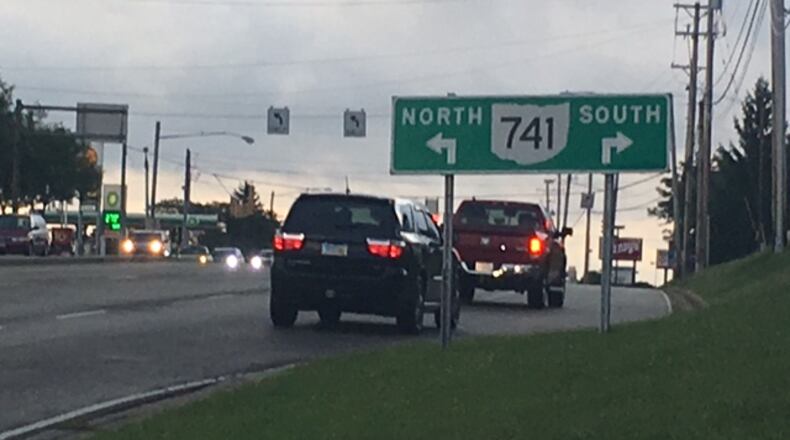 Miamisburg is taking initial steps to work with the Ohio Department of Transportation on a plan to replace ground-mounted signs before intersections with traffic signals - like this one along Ohio 725 - with overhead ones that are more visible for motorists. NICK BLIZZARD/STAFF