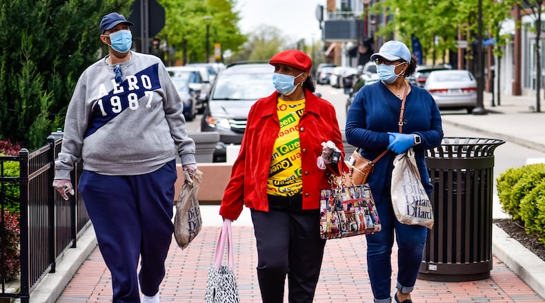 Joey Shields, left, Josephine Gates, middle, and Shelley Gates wear masks as they shop at Liberty Center in Liberty Township on the first day most retail stores were allowed to open Tuesday, May 12, 2020. Most non-essential retail stores have been closed to the public since the stay-at-home order went into place due to the coronavirus pandemic. NICK GRAHAM / STAFF