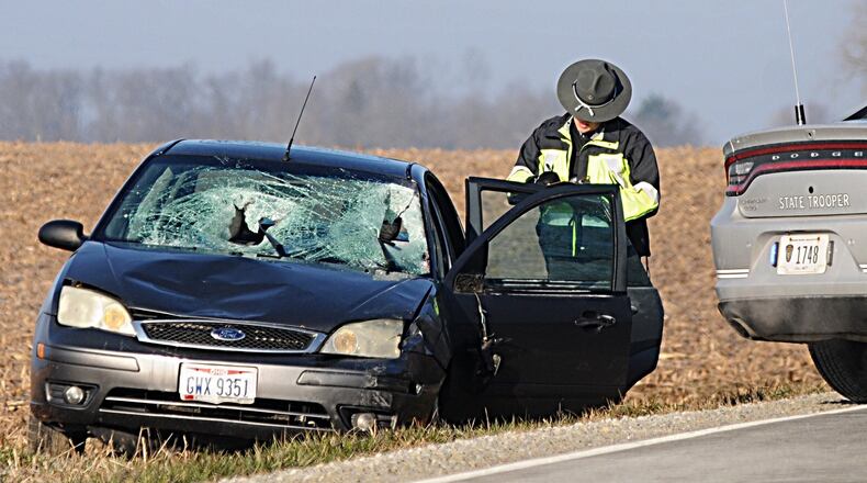 The Ohio State Highway Patrol investigate after two pedestrians were struck, one fatally, on Old Springfield Road in Clark County Tuesday morning. Marshall Gorby/Staff