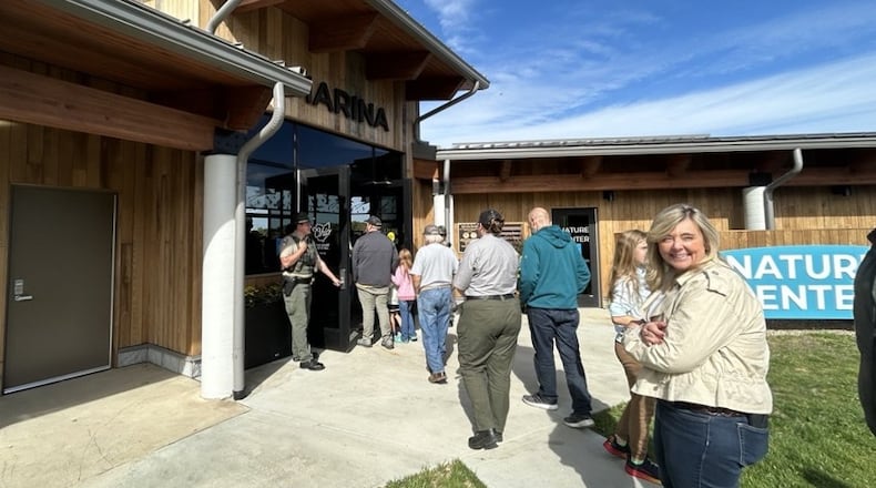 Springfield Communications Director Karen Graves enters the newly finished marina at Buck Creek State Park in Springfield with a group of people Friday, Oct. 17, 2025. JESSICA OROZCO/STAFF